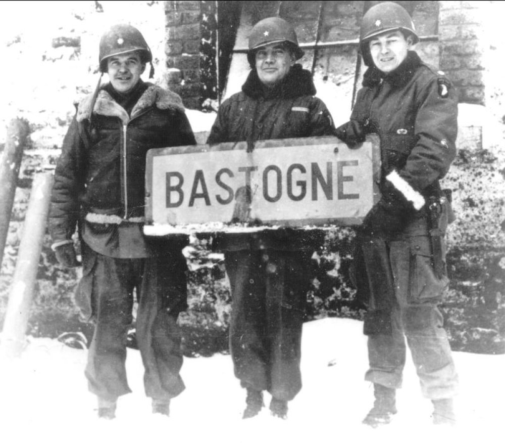In which combat arm of the U.S. Army did Anthony McAuliffe, who commanded the defenses of Bastogne during the Battle of the Bulge, serve?