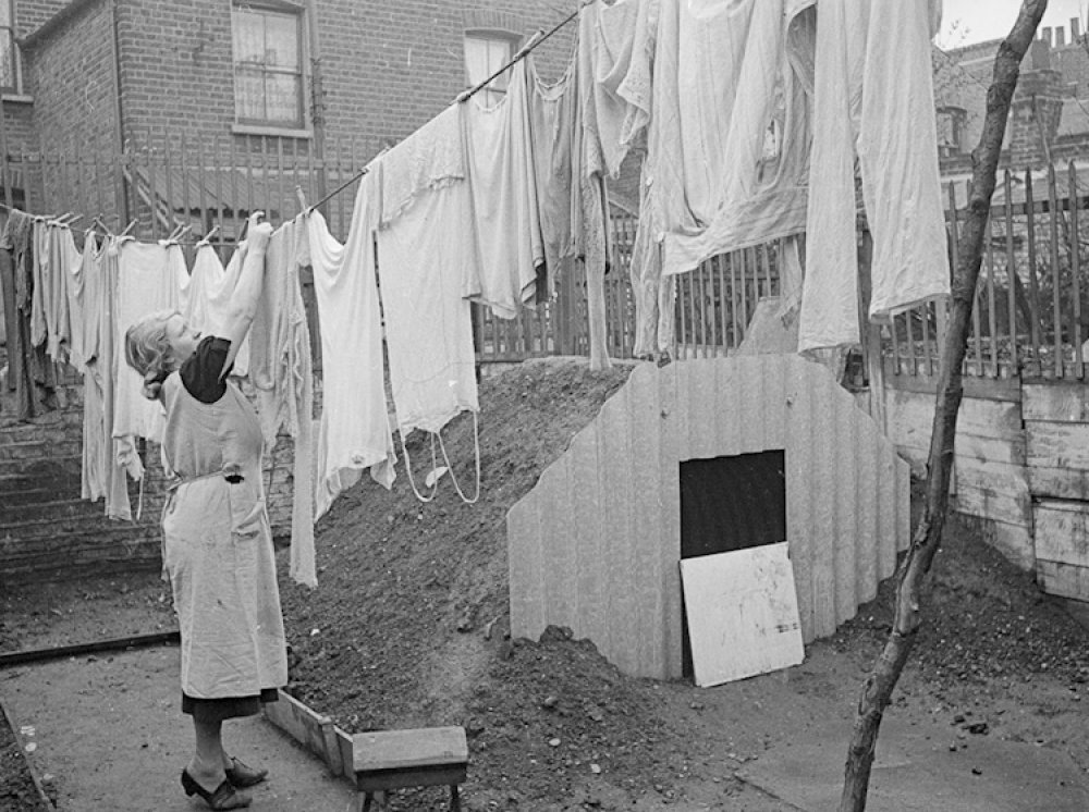 What is the name of the type of air-raid shelter seen in the photo, widely used in Britain during World War II?