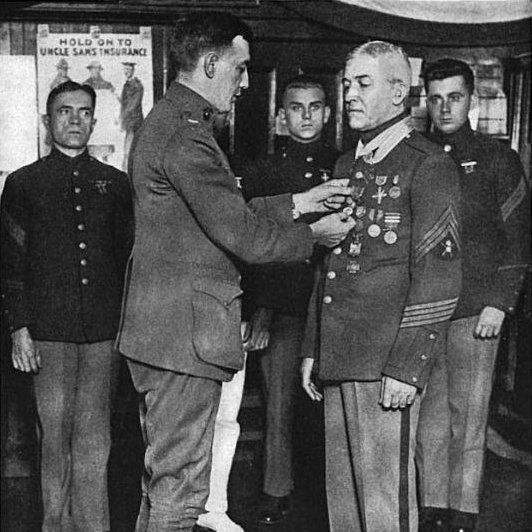 For what action did Daniel Daly, the U.S. Marine who famously and allegedly shouted 'Come on, you sons-o'-bitches, do you want to live forever?' at the Battle of Belleau Wood in World War I, receive his first Medal of Honor out of two?