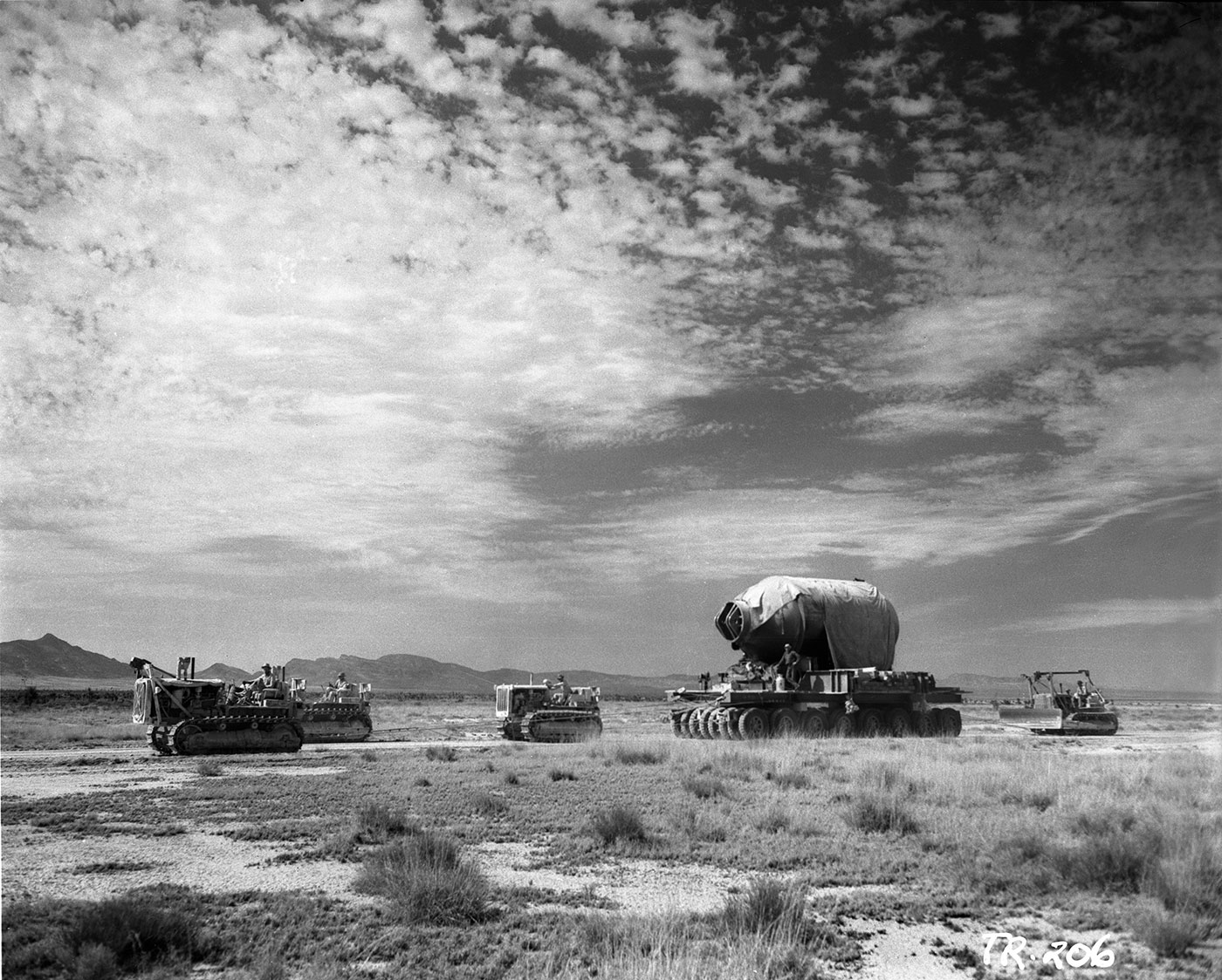 What is the geographical name of the desert basin in which the Trinity test, the first detonation of a nuclear bomb, occurred on July 16, 1945?