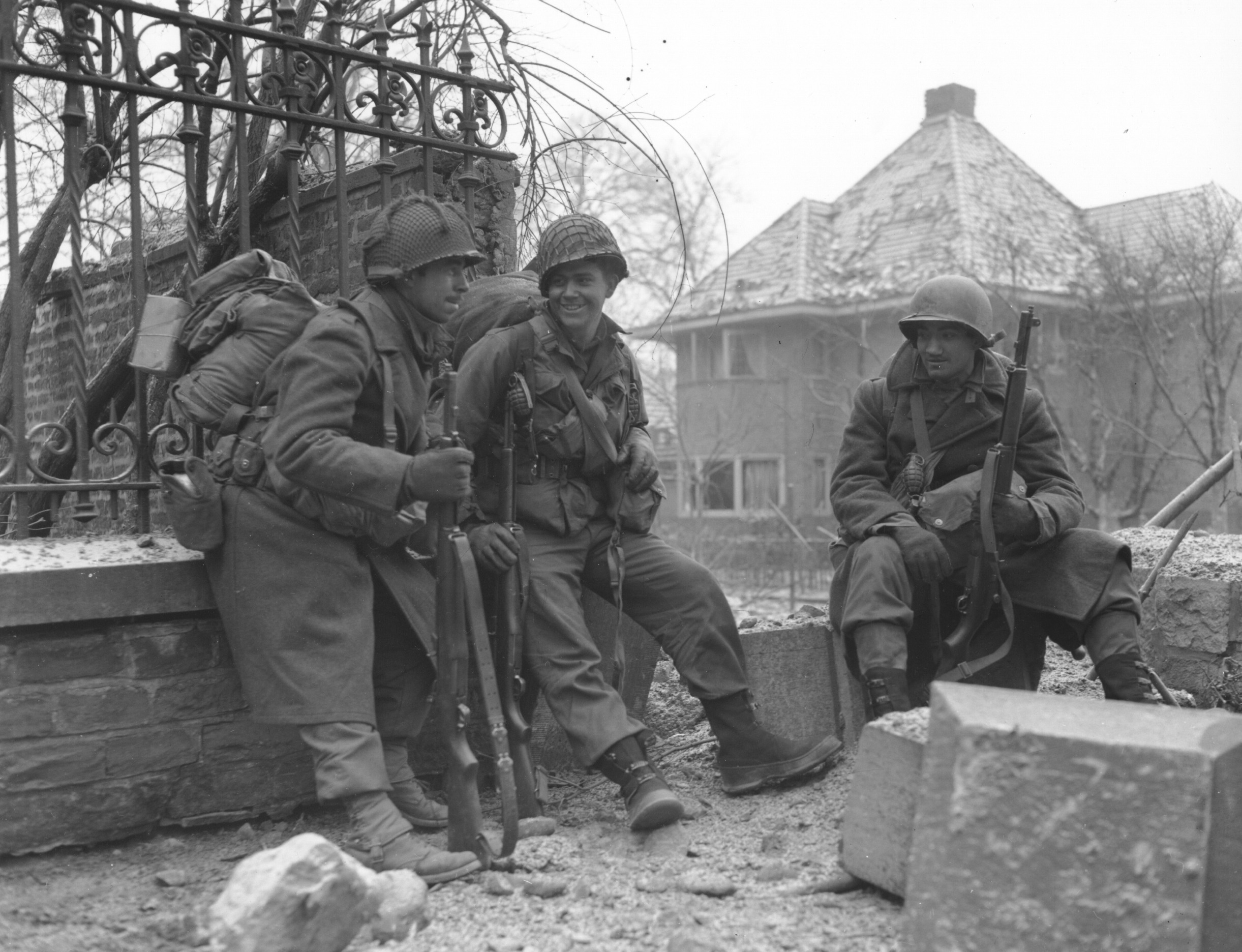 Which American-held town became a critical location when it was fully surrounded by German troops that needed to capture the local transport hub?