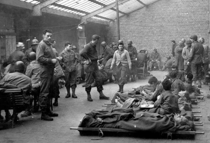 Where did the 10th Armored Division, which defended Bastogne alongside the 101st Airborne and other units, have its medical aid station for most of the siege?