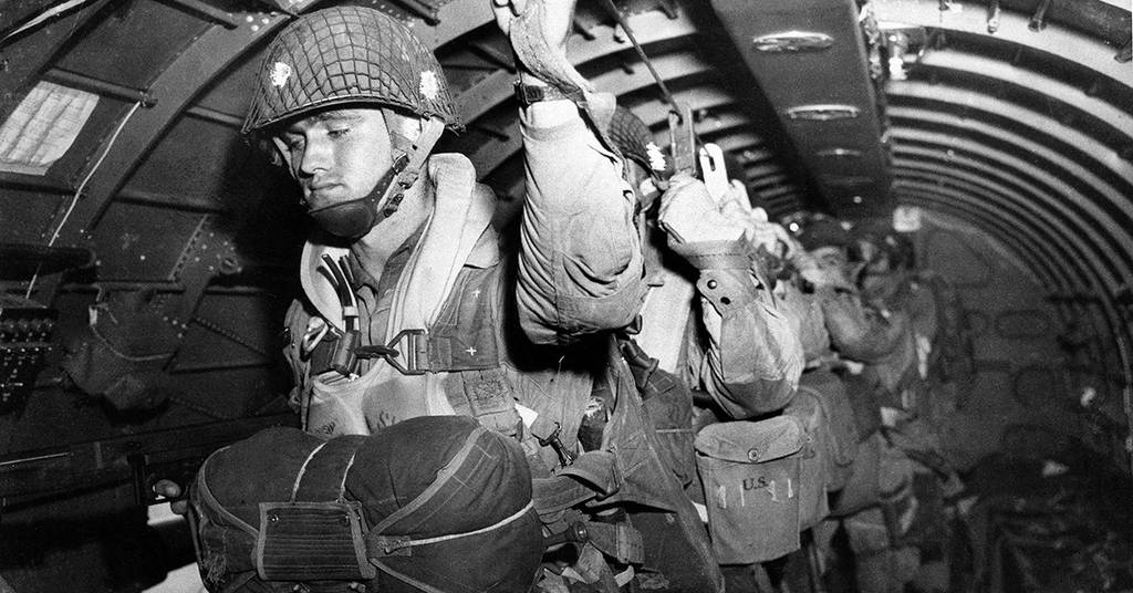 How many Allied airborne divisions landed troops behind German lines on the night before D-Day?