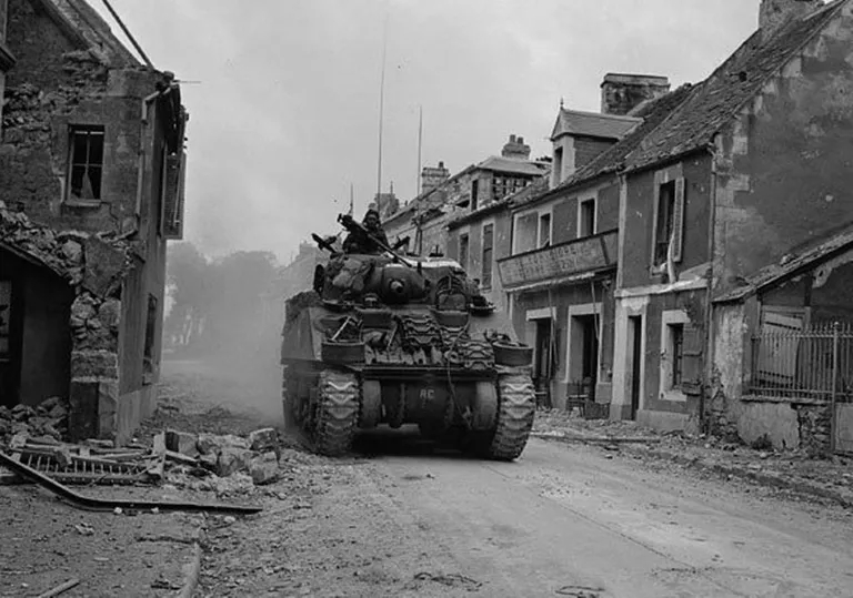Which German-occupied town or city was supposed to be liberated on D-Day, only to frustrate the Allies by holding out until early August?